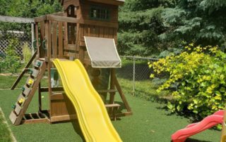 Used artificial turf being utilized as a playground floor.