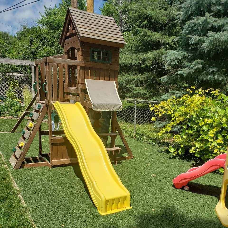 Used artificial turf being utilized as a playground floor.