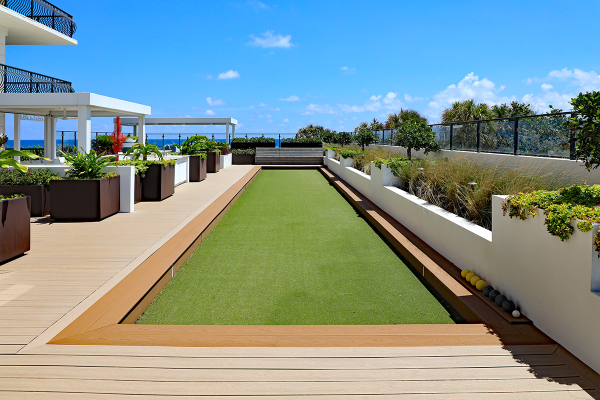 Inviting upscale bocce ball court with artificial turf, on a roof